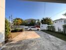 Spacious driveway in a residential property with a white car