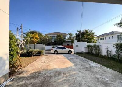 Spacious driveway in a residential property with a white car