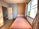 Cozy bedroom with natural light and wooden finishes