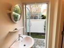 Compact bathroom with natural light and garden access