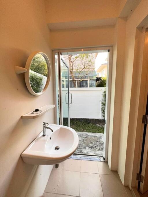 Compact bathroom with natural light and garden access