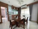 Spacious dining room with modern wooden furniture and natural light