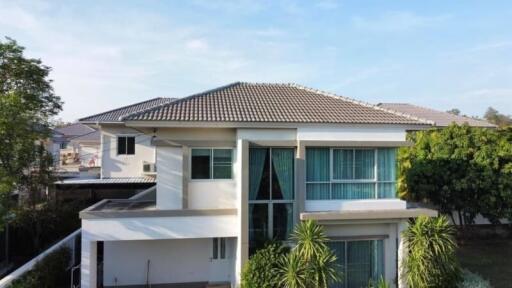 Modern two-story house with lush greenery