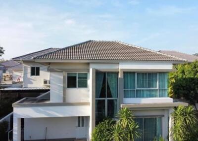 Modern two-story house with lush greenery