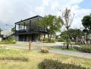 Modern building with spacious lawn and playground