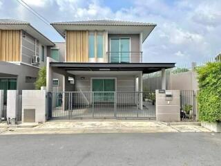 Modern two-story house with balcony and protected parking