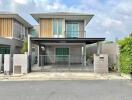 Modern two-story house with balcony and protected parking