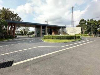 Modern residential building entrance with landscaped driveway