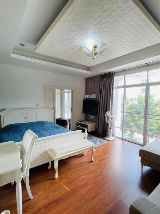 Spacious and elegantly furnished bedroom with natural lighting