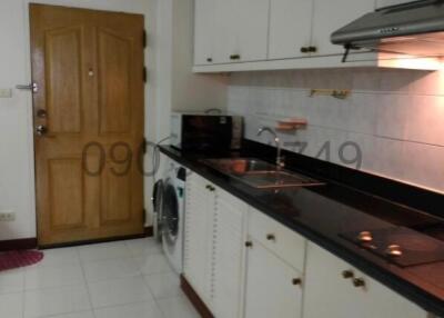 Modern kitchen with white cabinets and built-in appliances