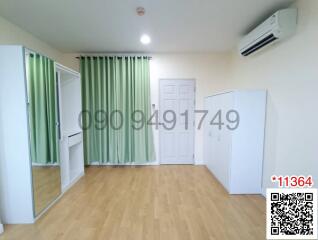 Spacious and well-lit bedroom with green curtains and air conditioner