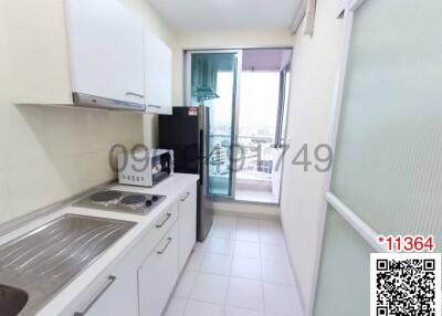 Compact and bright kitchen with modern appliances and balcony access
