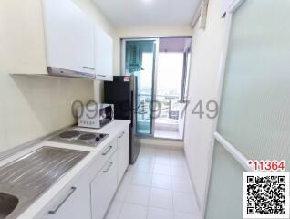 Compact and bright kitchen with modern appliances and balcony access