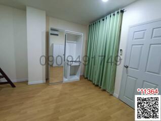 Spacious bedroom with large wardrobe and hardwood floors