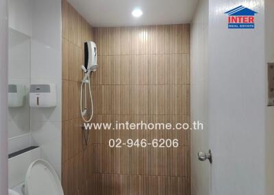 Modern bathroom interior with shower and wooden wall tiles