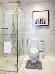 Modern bathroom with glass shower and marble finish