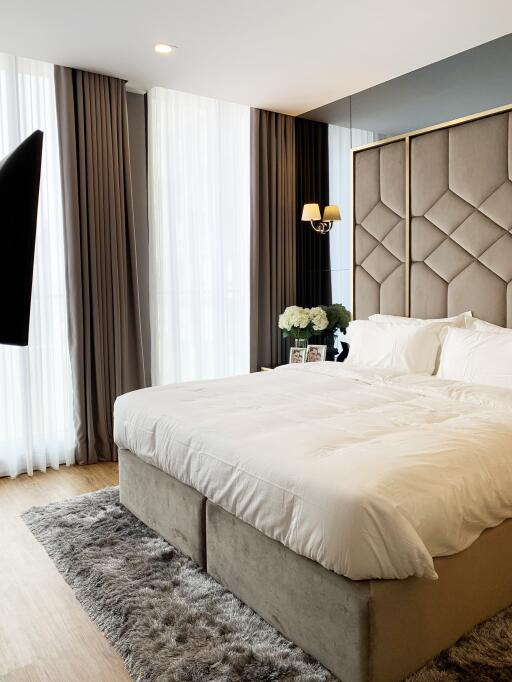 Elegant modern bedroom with large bed and stylish decor