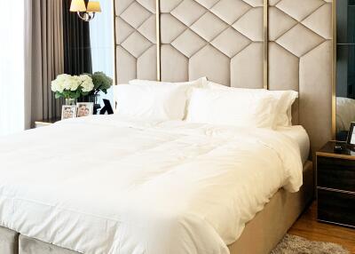 Elegant modern bedroom with large upholstered bed and stylish decor
