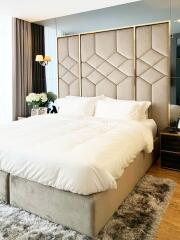 Elegant modern bedroom with large upholstered bed and stylish decor