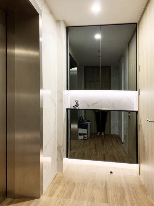 Modern hallway interior with marble accents and wooden flooring