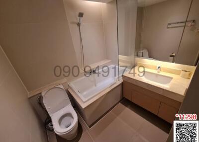 Modern bathroom with bathtub, shower, and vanity