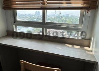 Cozy study room with wooden blinds and city view
