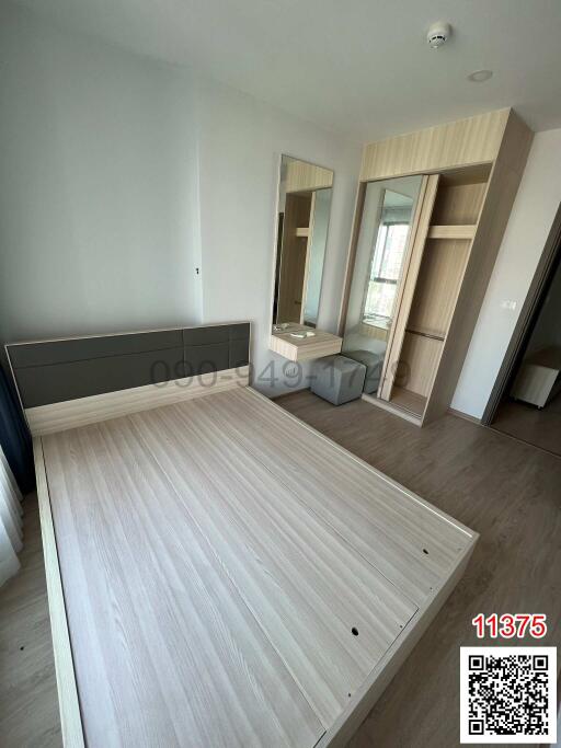 Spacious bedroom with wooden flooring, ample natural light, and built-in wardrobe