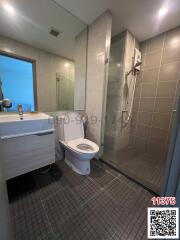 Modern bathroom with glass shower and tiled flooring