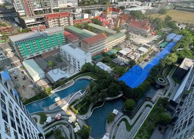 Aerial view of a modern residential complex with lush landscaping and a pool