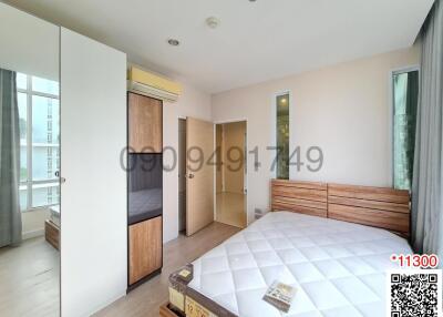 Spacious bedroom with ample natural light and modern furniture