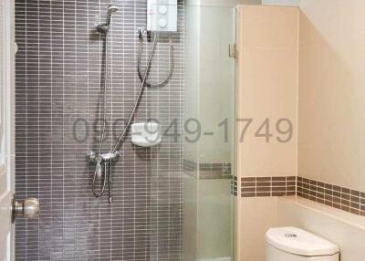 Modern bathroom with shower area and toilet