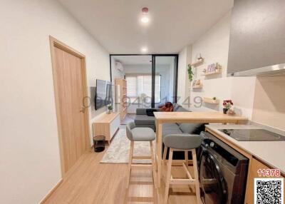 Modern compact kitchen with integrated living space featuring contemporary furnishings and ample natural light