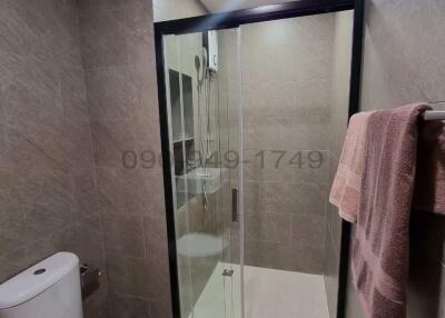 Modern bathroom with glass shower enclosure and stylish tiles