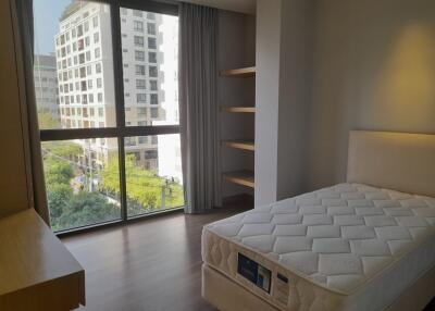 Spacious bedroom with large window and city view