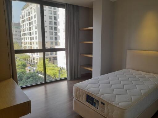 Spacious bedroom with large window and city view