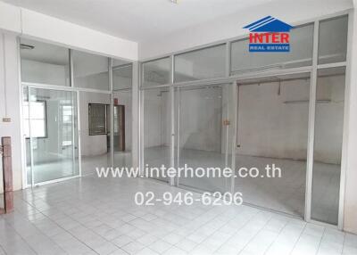 Open interior space with tiled floor and glass partitions