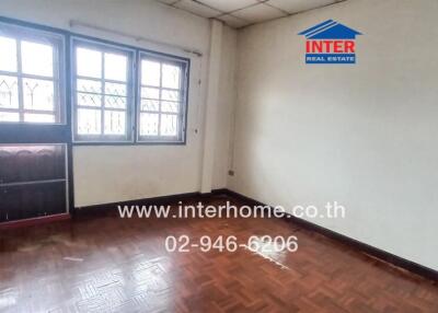 Empty room with windows and wooden floor