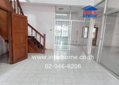 Spacious main living area with stairs and visible glass partition.