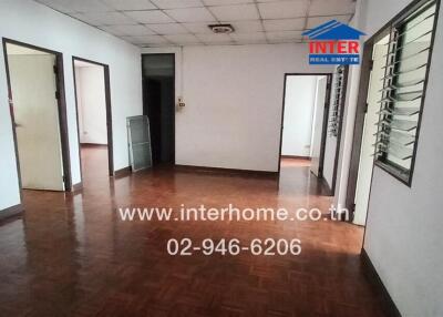 Spacious empty room with wooden flooring