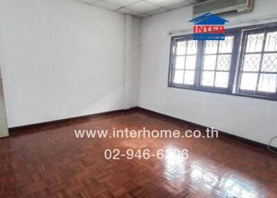 Empty bedroom with wooden floor and window