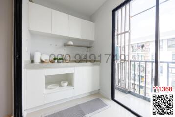 Modern, compact kitchen with large window and city view