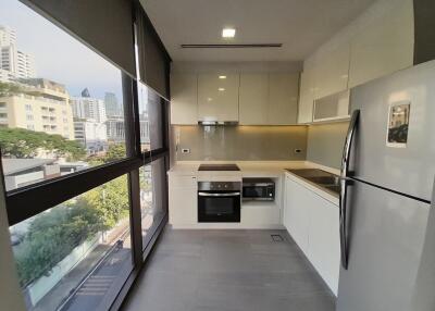 Modern kitchen with built-in appliances and city view