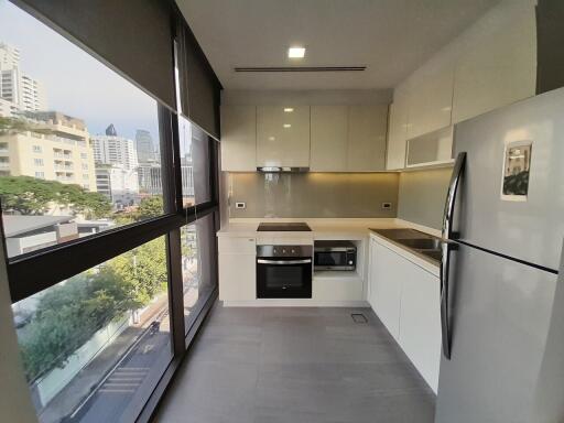 Modern kitchen with built-in appliances and city view