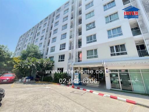 Exterior view of a modern apartment building with ground floor commercial spaces