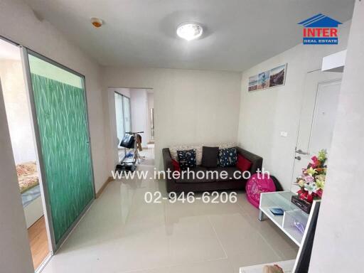 Bright and neatly organized living room with sliding glass door and comfortable seating