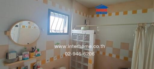 Bright and modern bathroom interior with shelving unit and a circle mirror