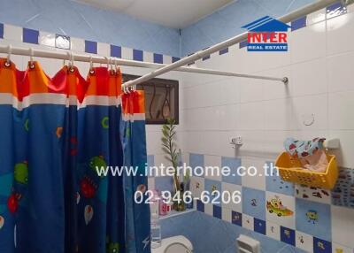 Brightly decorated bathroom with a colorful shower curtain