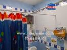 Brightly decorated bathroom with a colorful shower curtain