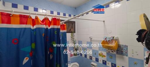 Brightly decorated bathroom with a colorful shower curtain