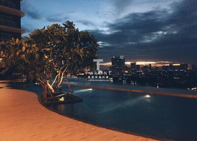 Luxurious rooftop pool with city skyline view at dusk